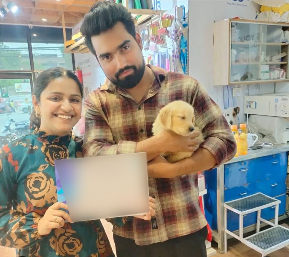 Couple holding their new Golden Retriever puppy in Delhi NCR