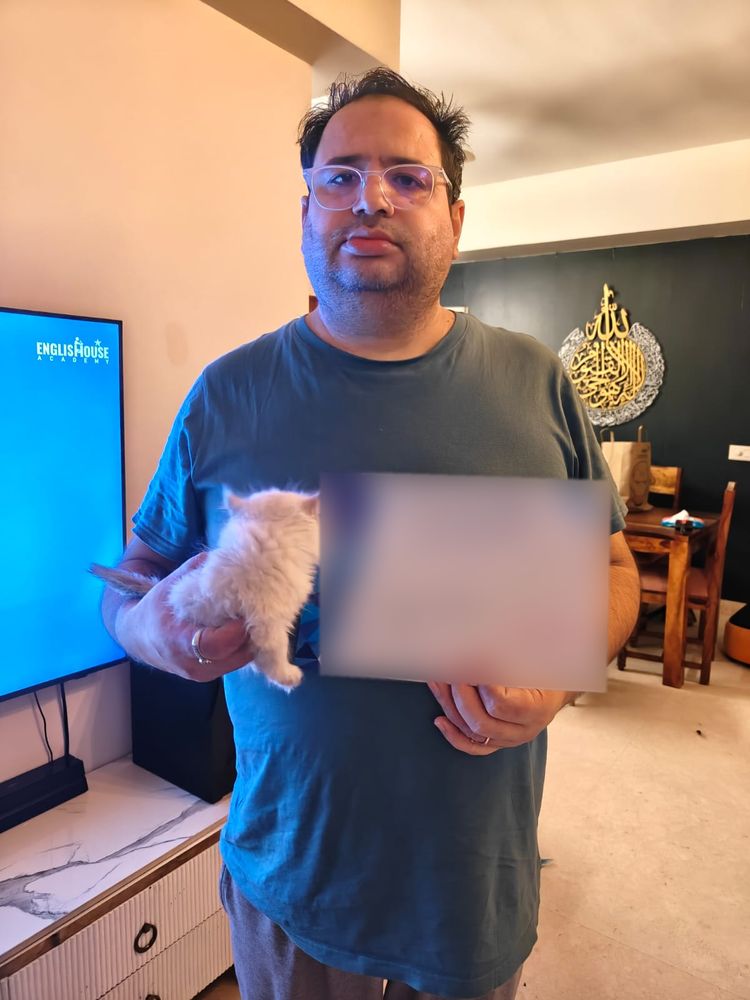 Customer holding his new Persian kitten at home in Delhi NCR