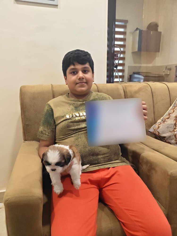 Boy with his new Shih Tzu puppy at home in Delhi NCR